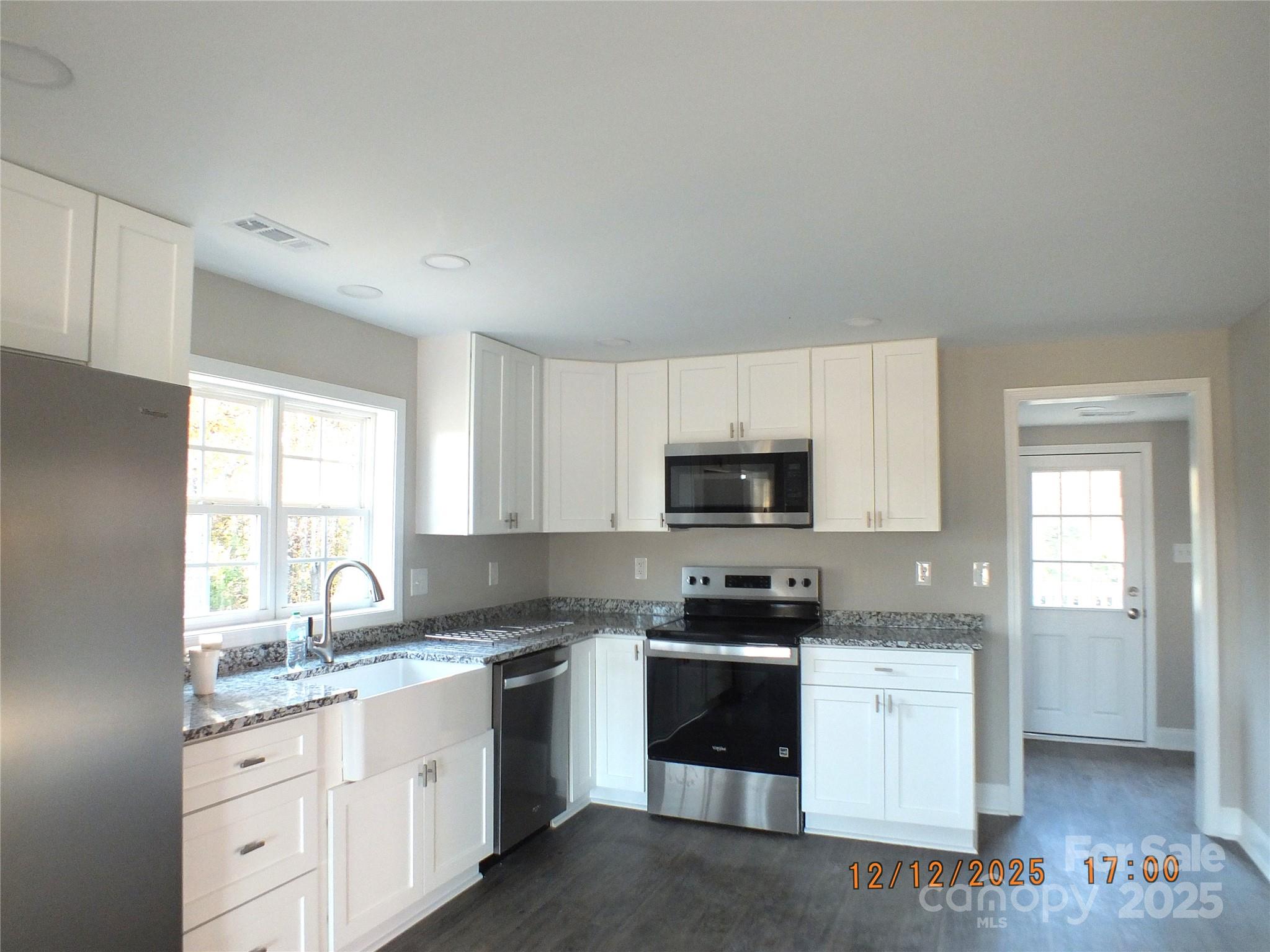 1740 Rocky River Road Lancaster, SC 29720 - Photo 3 of 31 a kitchen with granite countertop a sink a window and stainless steel appliances