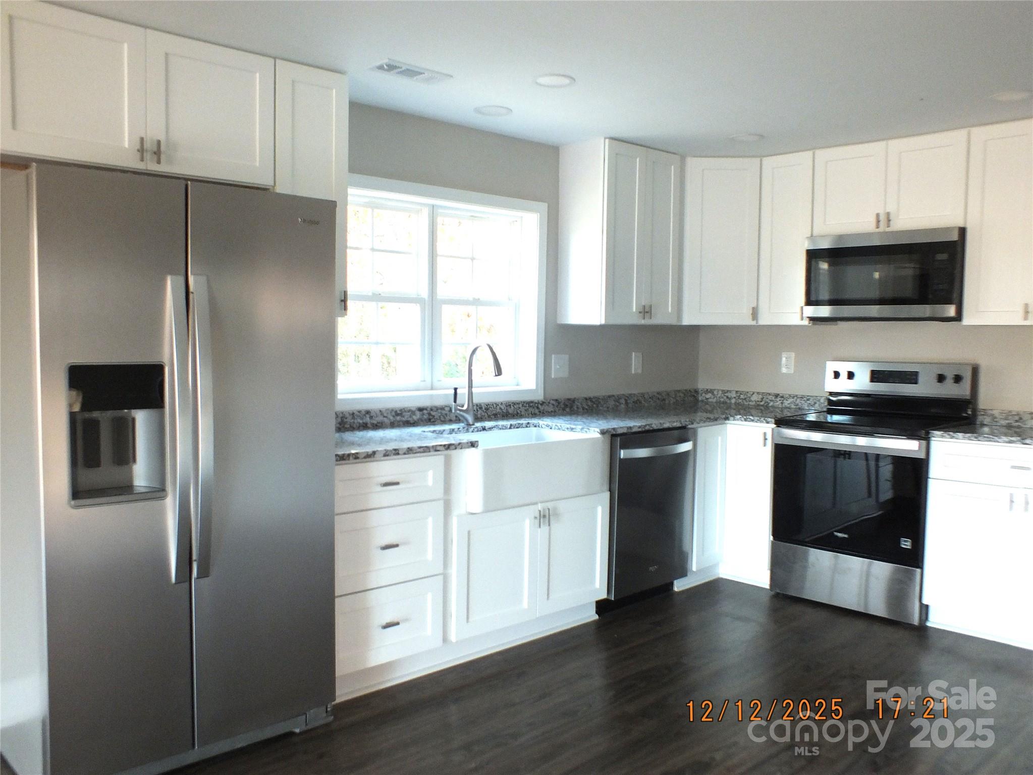 1740 Rocky River Road Lancaster, SC 29720 - Photo 6 of 31 a kitchen with a refrigerator stove and microwave