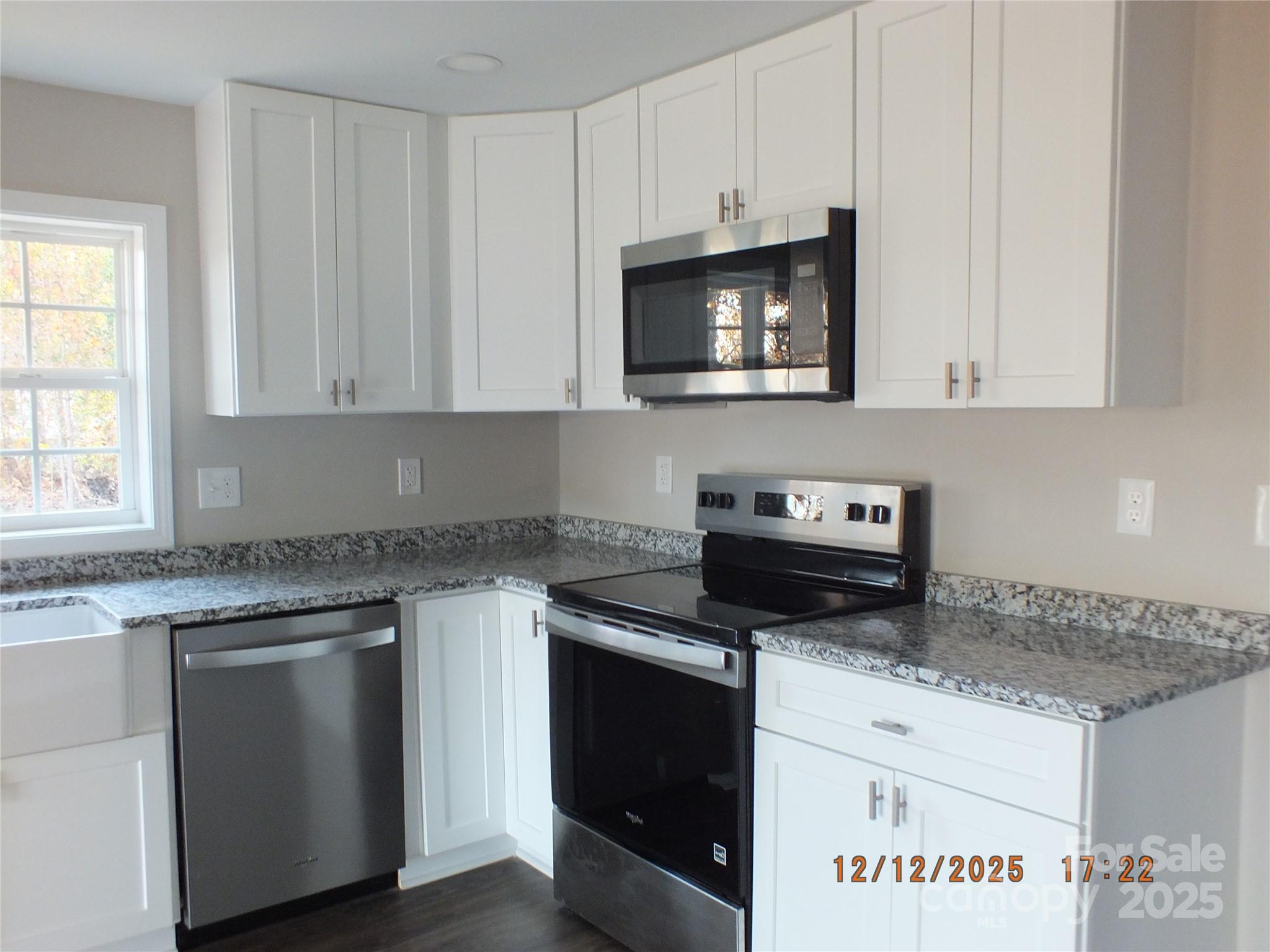 1740 Rocky River Road Lancaster, SC 29720 - Photo 7 of 31 a kitchen with granite countertop white cabinets stainless steel appliances and a sink
