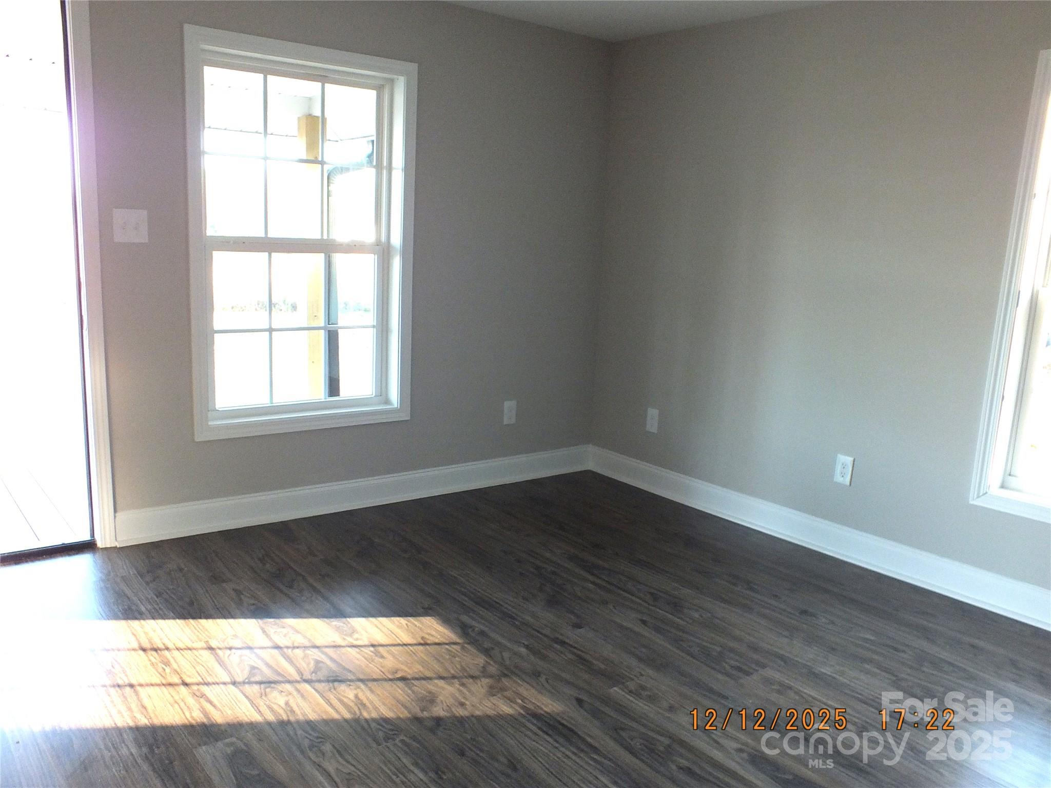 1740 Rocky River Road Lancaster, SC 29720 - Photo 10 of 31 an empty room with wooden floor and windows