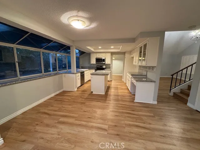 a view of a living room a kitchen and dining room