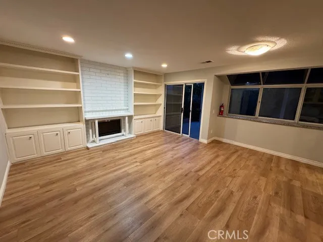 a view of a livingroom with wooden floor and staircase