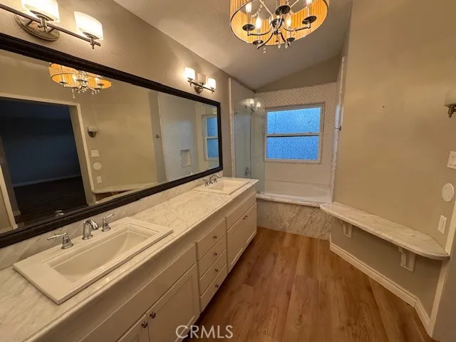 a bathroom with a sink a large mirror and a shower