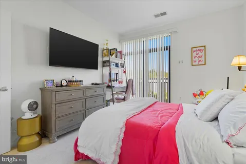 a bedroom with a bed and flat screen tv