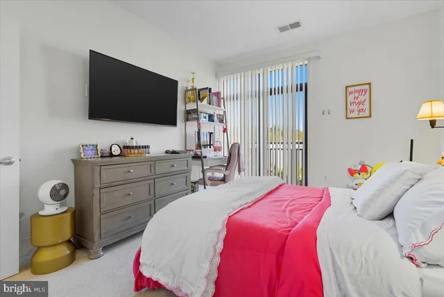 a bedroom with a bed and flat screen tv