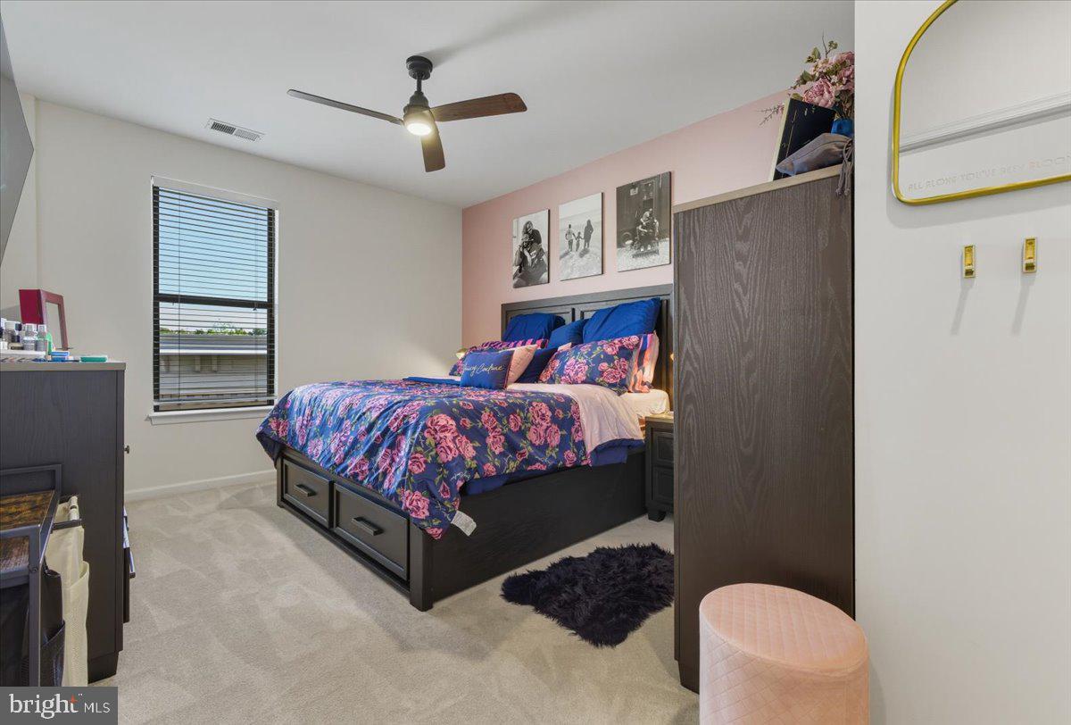 9000 Lorton Station Boulevard, Unit 2115 Lorton, VA 22079 - Photo 18 of 35 a bedroom with a bed dresser and a window