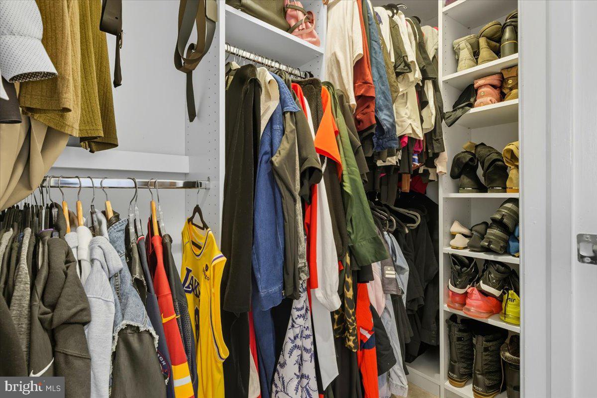 9000 Lorton Station Boulevard, Unit 2115 Lorton, VA 22079 - Photo 21 of 35 a view of walk in closet with clothes and shoes