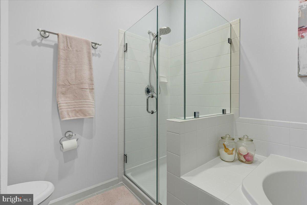 9000 Lorton Station Boulevard, Unit 2115 Lorton, VA 22079 - Photo 24 of 35 a bathroom with a shower and toilet