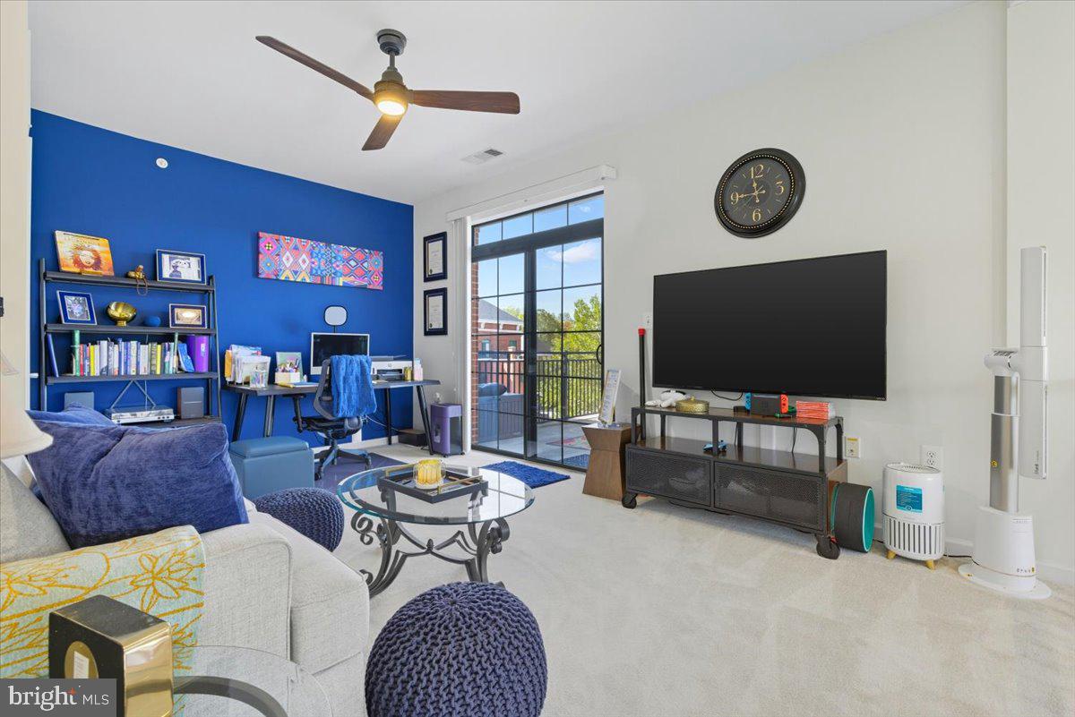 9000 Lorton Station Boulevard, Unit 2115 Lorton, VA 22079 - Photo 26 of 35 a living room with furniture and a flat screen tv