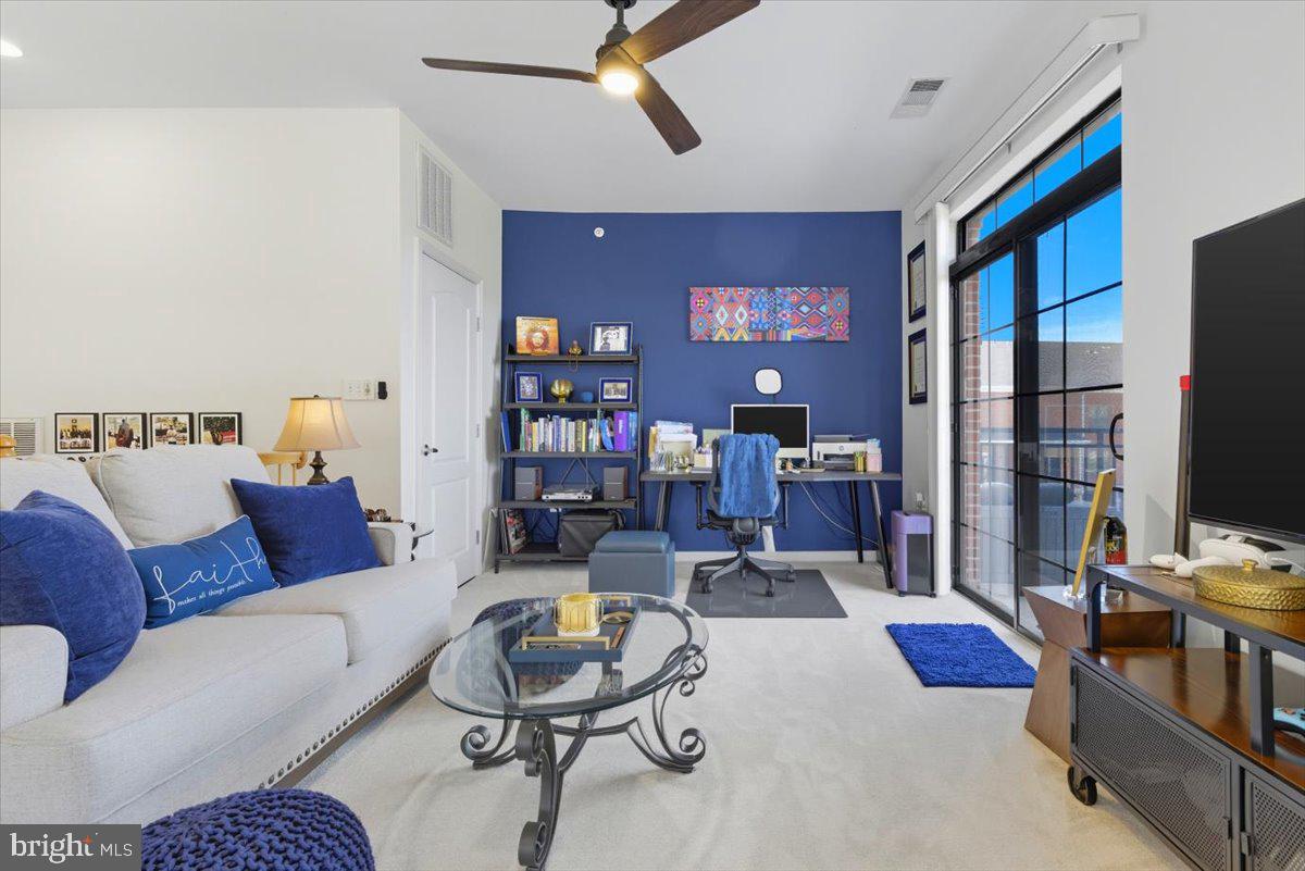 9000 Lorton Station Boulevard, Unit 2115 Lorton, VA 22079 - Photo 27 of 35 a living room with furniture and a flat screen tv