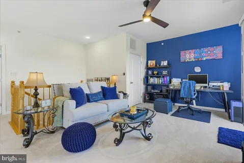 a living room with furniture and a bookshelf
