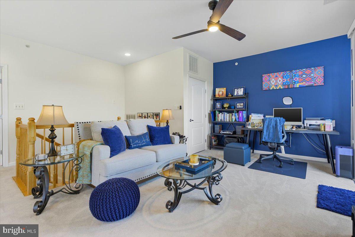 9000 Lorton Station Boulevard, Unit 2115 Lorton, VA 22079 - Photo 28 of 35 a living room with furniture and a bookshelf