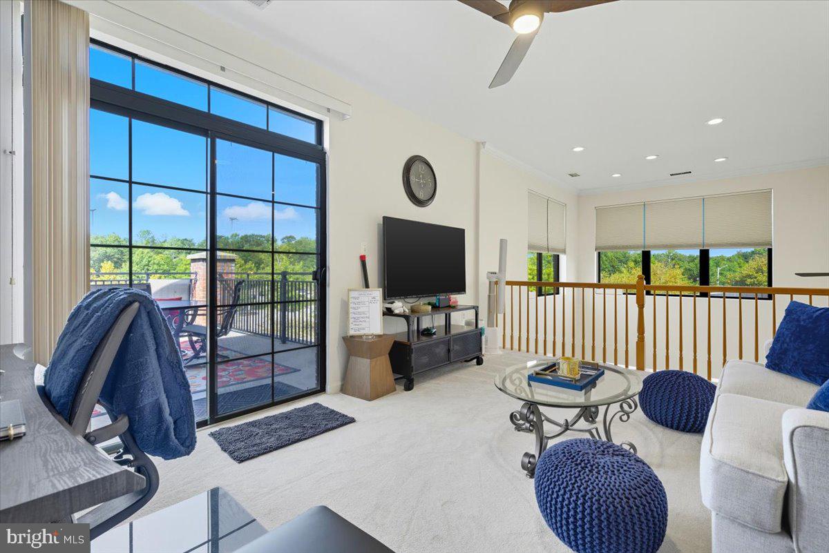 9000 Lorton Station Boulevard, Unit 2115 Lorton, VA 22079 - Photo 29 of 35 a living room with furniture a flat screen tv and floor to ceiling window