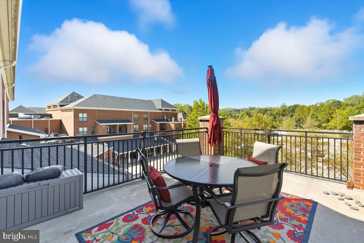 9000 Lorton Station Boulevard, Unit 2115 Lorton, VA 22079 - Photo 32 of 35 a view of a balcony with furniture and a table
