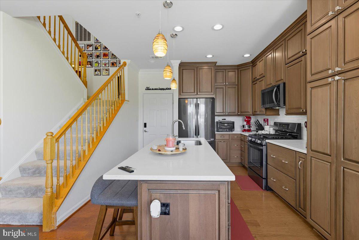 9000 Lorton Station Boulevard, Unit 2115 Lorton, VA 22079 - Photo 8 of 35 a kitchen with sink a refrigerator and microwave