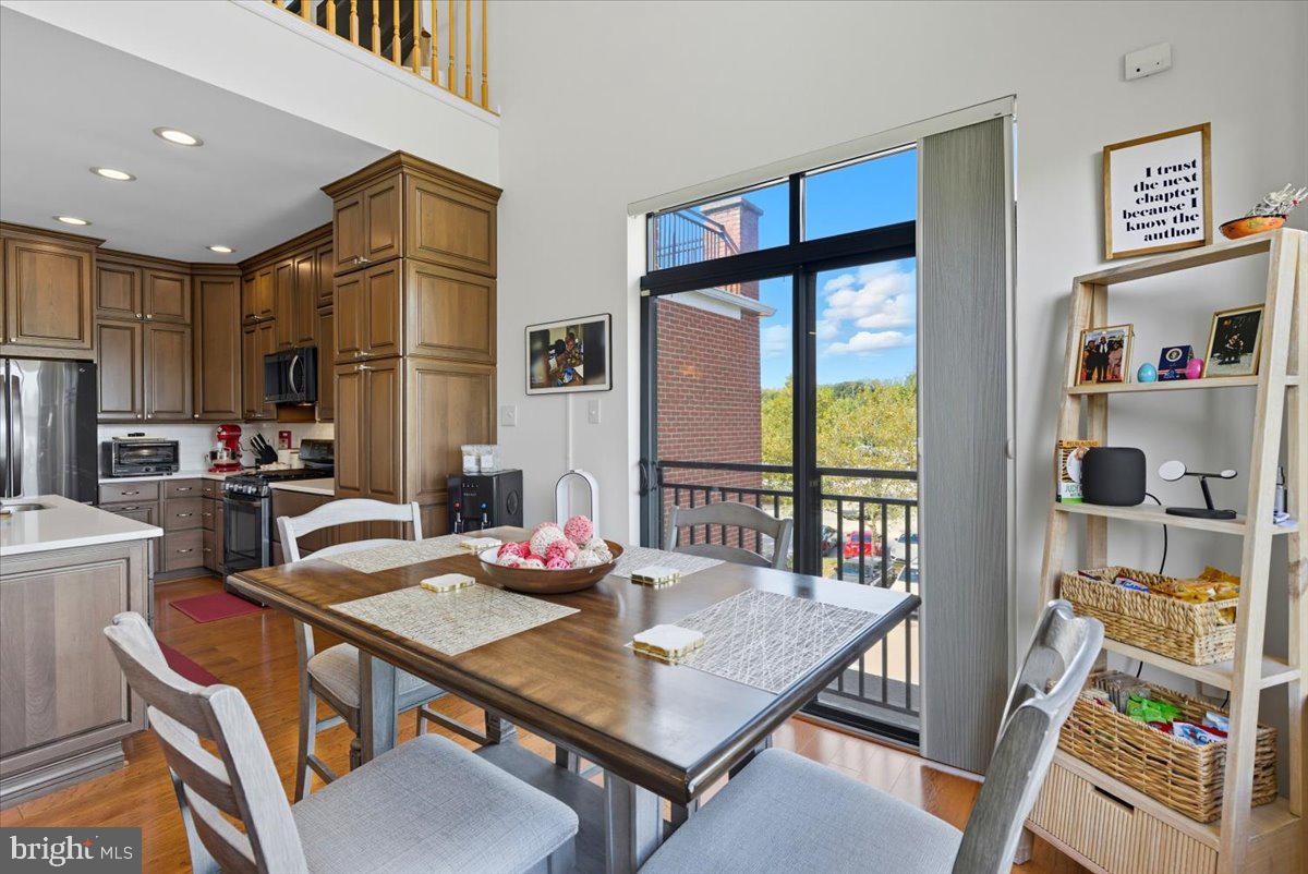 9000 Lorton Station Boulevard, Unit 2115 Lorton, VA 22079 - Photo 10 of 35 a view of a dining room with furniture a chandelier and wooden floor