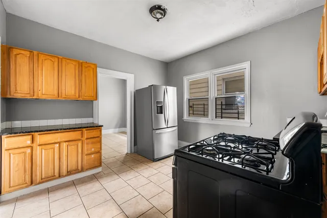 a kitchen with stainless steel appliances granite countertop a stove a refrigerator and a sink