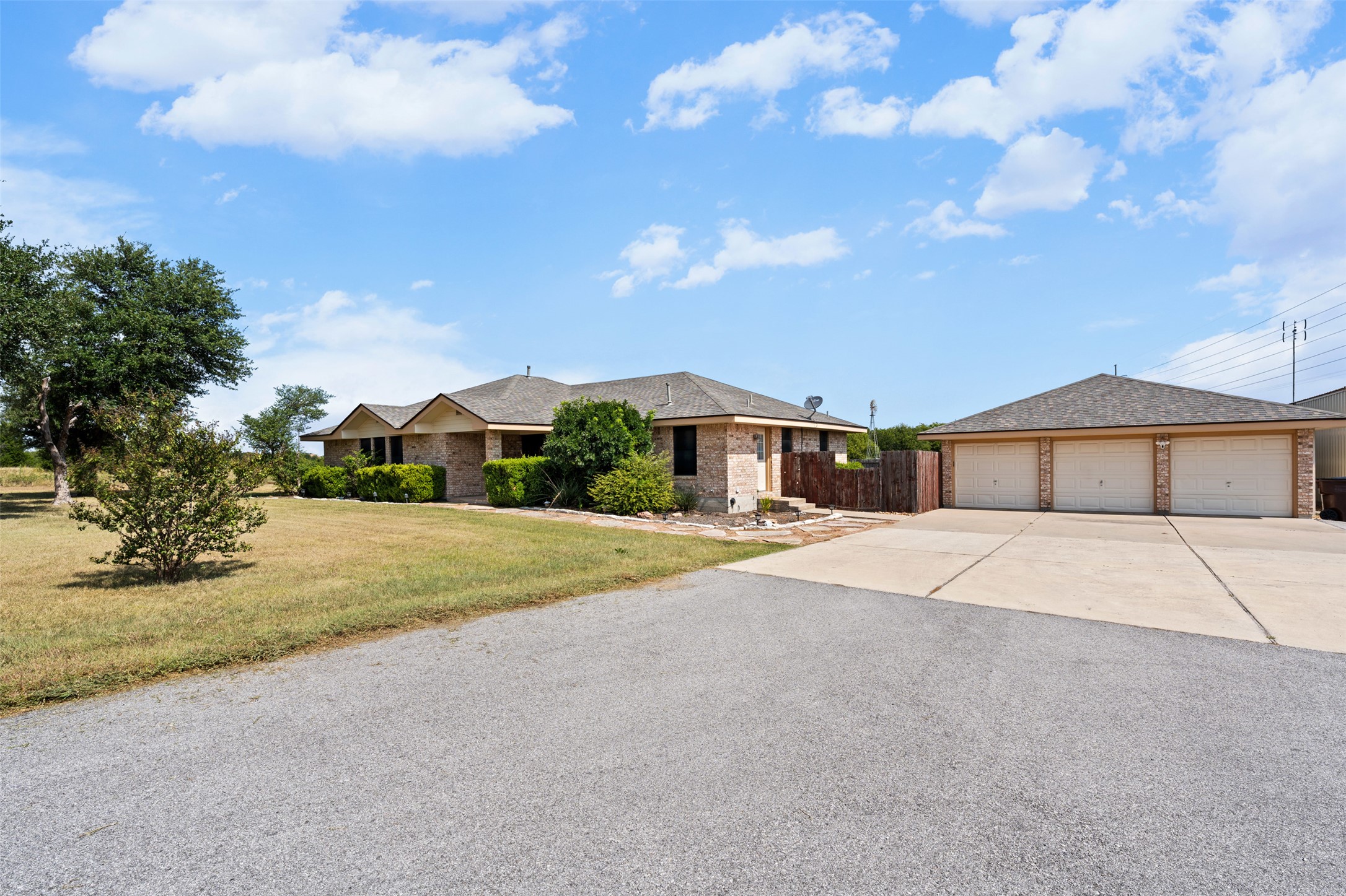 1512 Panther Loop Pflugerville, TX 78660 - Photo 3 of 40 A well-maintained brick residence featuring a generous driveway and attached garage.