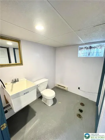 a bathroom with a sink mirror and toilet