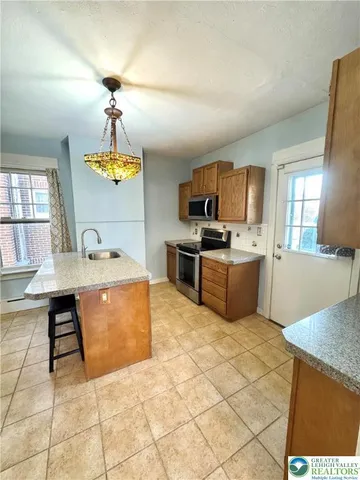 a kitchen with cabinets and window