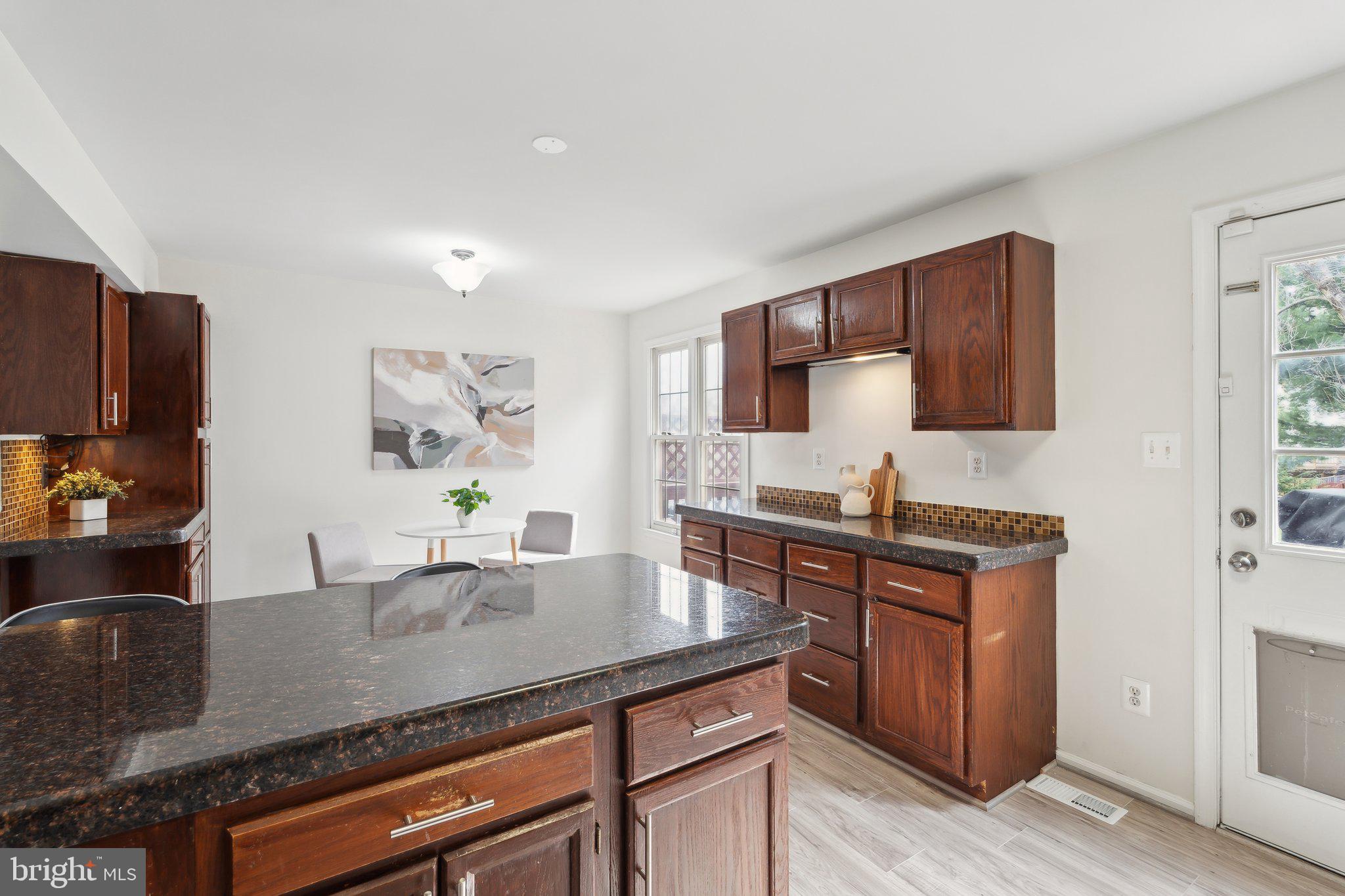 46924 Rabbitrun Terrace Sterling, VA 20164 - Photo 14 of 38 a kitchen with stainless steel appliances granite countertop a sink stove and refrigerator