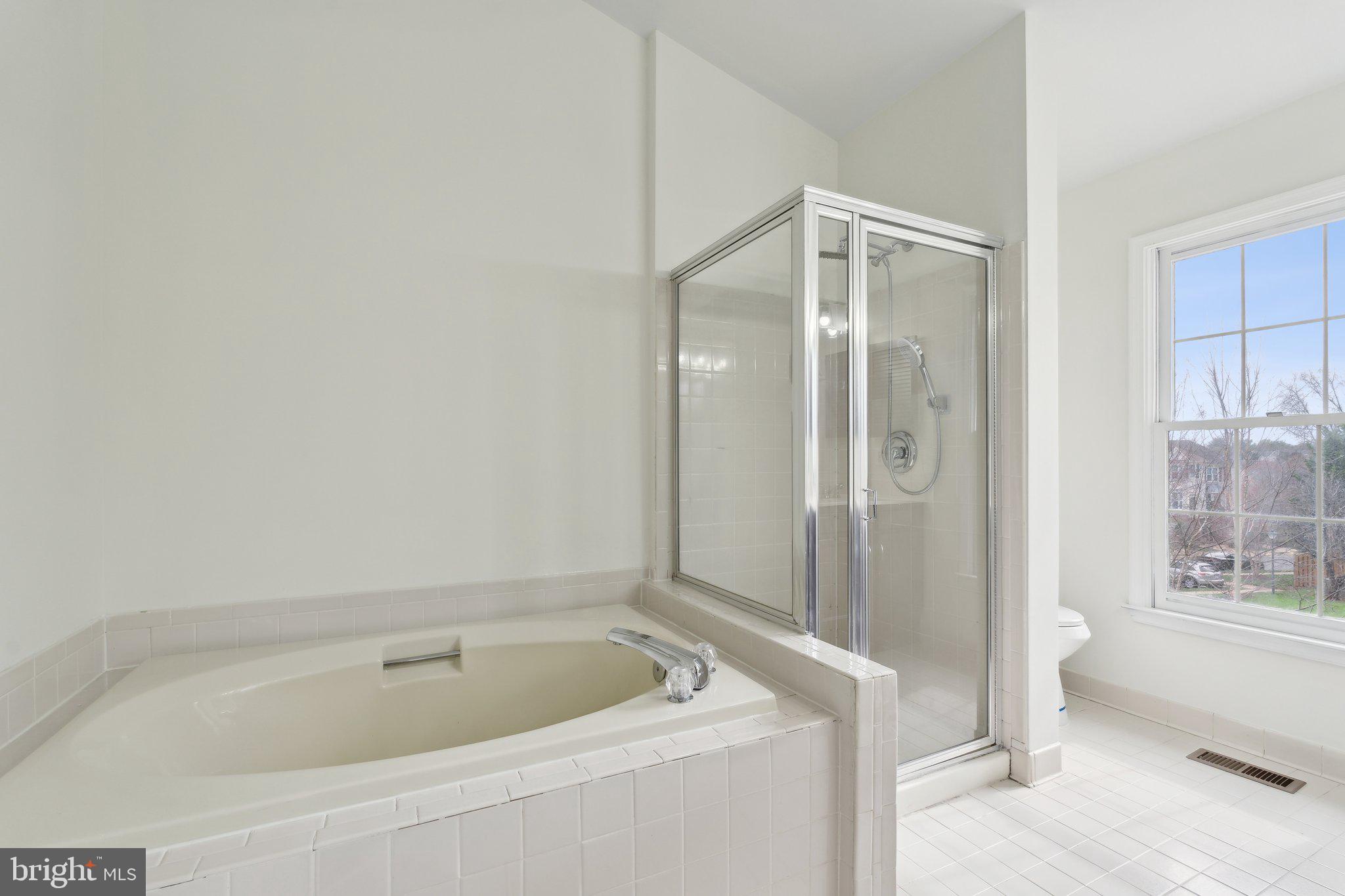 46924 Rabbitrun Terrace Sterling, VA 20164 - Photo 24 of 38 a bathroom with a tub and shower