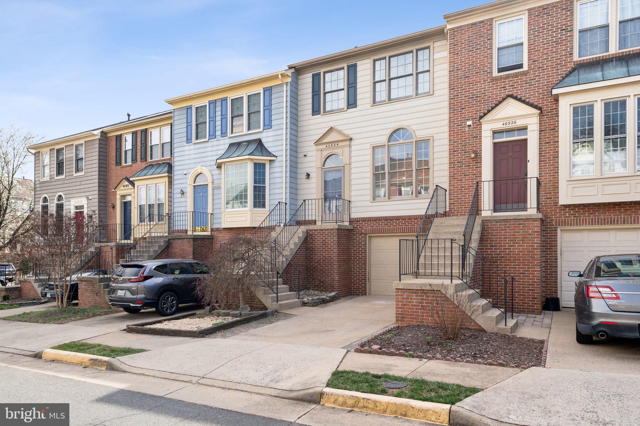 46924 Rabbitrun Terrace Sterling, VA 20164 - Photo 3 of 38 a front view of a building with parking space