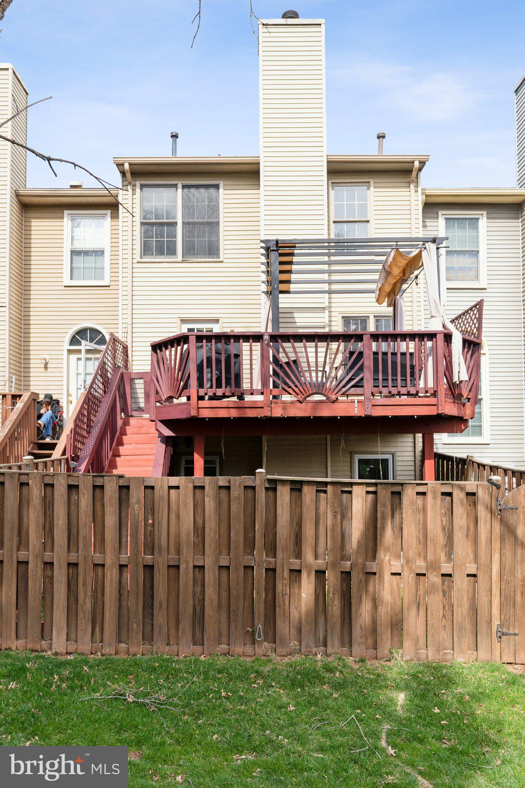 46924 Rabbitrun Terrace Sterling, VA 20164 - Photo 35 of 38 a backyard of a house with wooden deck and outdoor seating