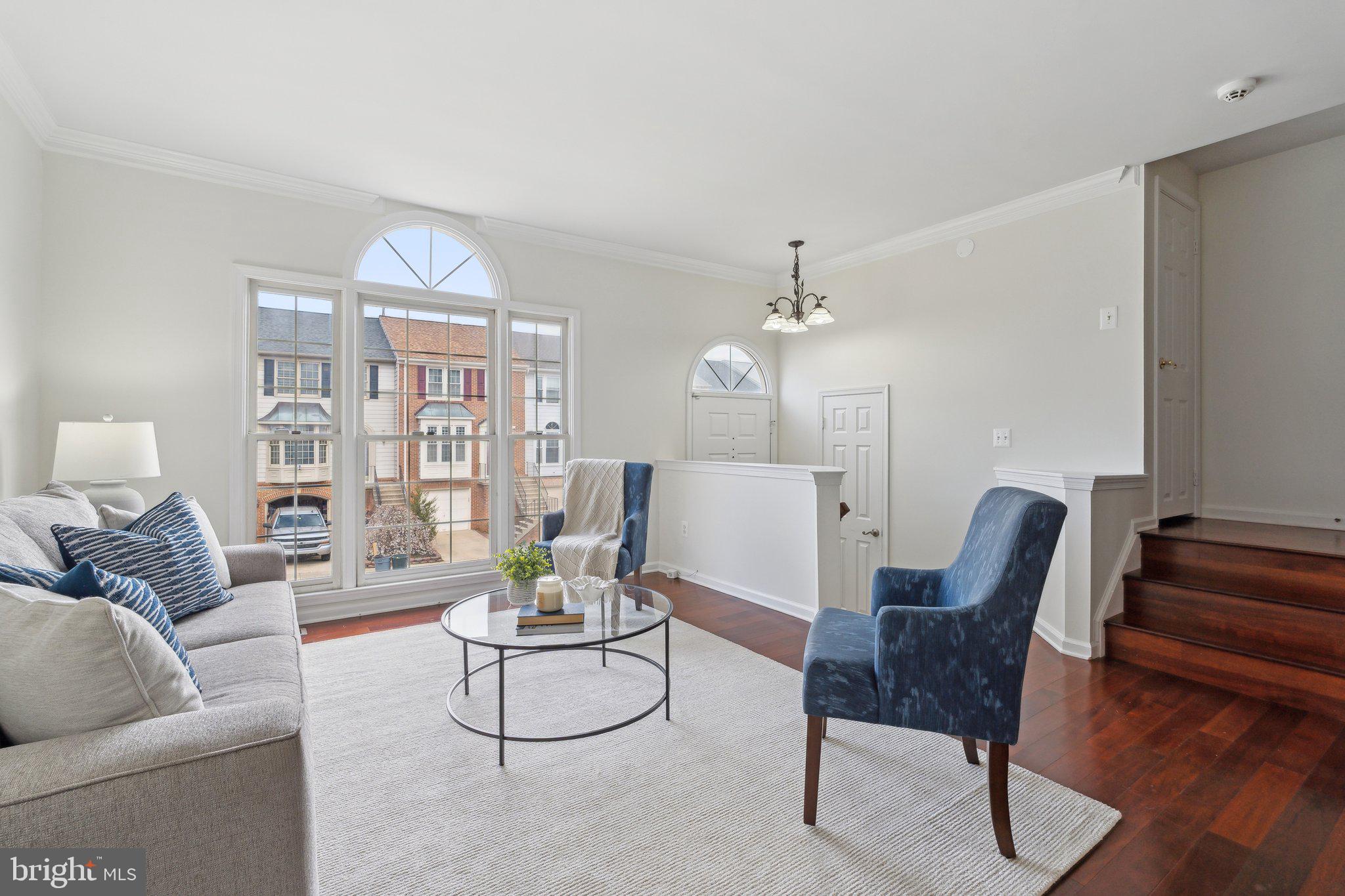46924 Rabbitrun Terrace Sterling, VA 20164 - Photo 7 of 38 a living room with furniture a rug and a chandelier