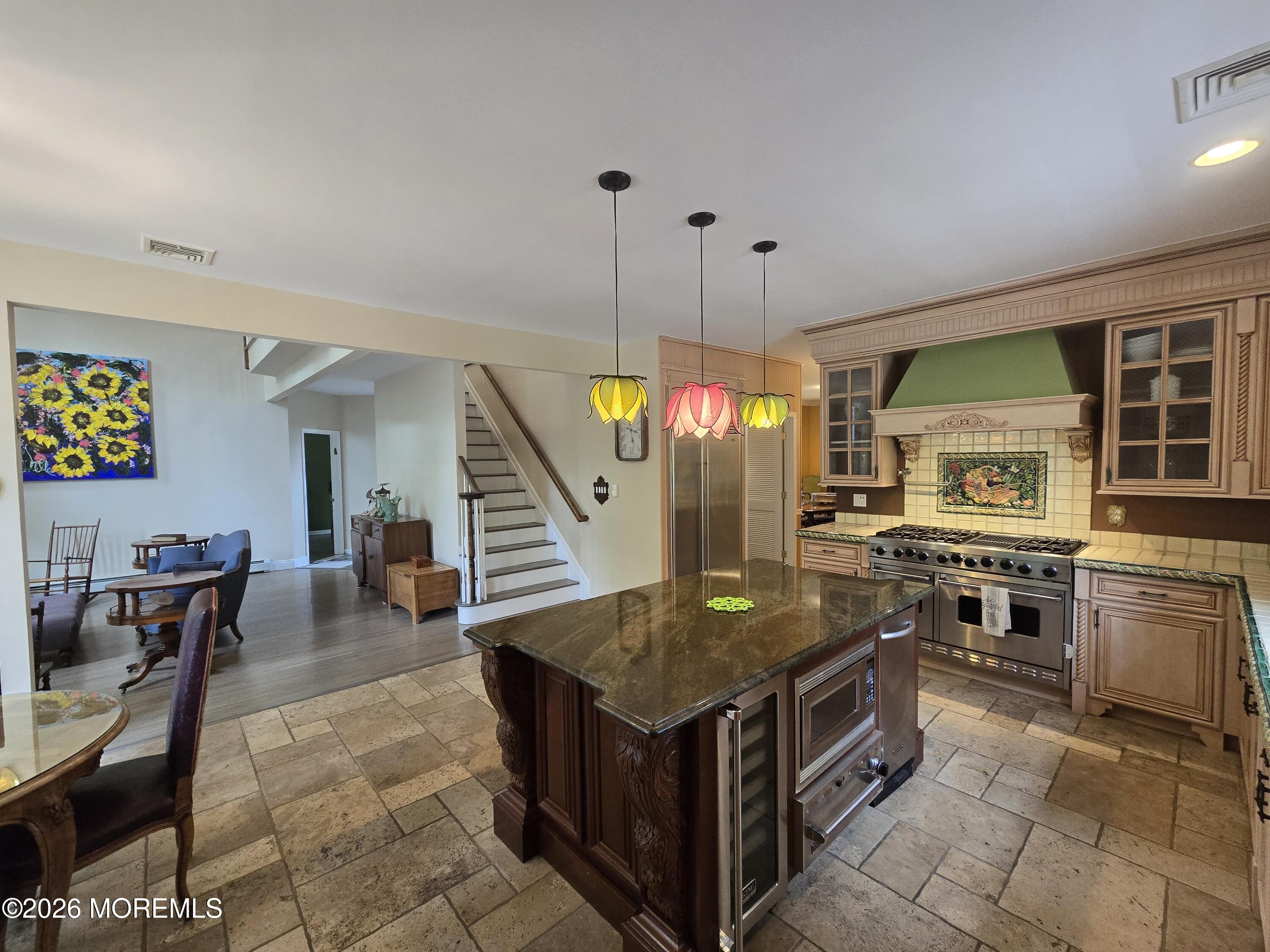 112 Beacon Hill Road Morganville, NJ 07751 - Photo 4 of 53 a kitchen with a stove a refrigerator and chairs