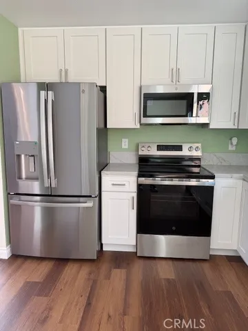 a kitchen with a stove a microwave and a refrigerator