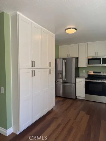 a kitchen with wooden cabinets and stainless steel appliances