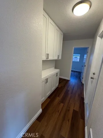 a view of a room with wooden floor and a window