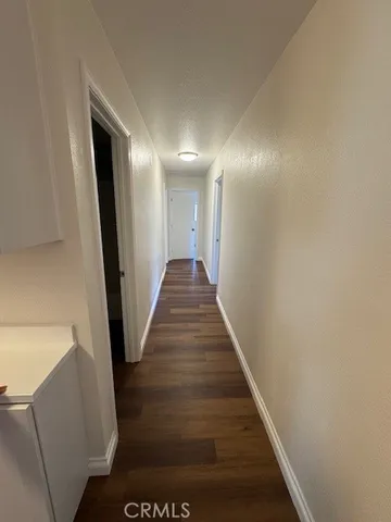 a view of a hallway with wooden floor