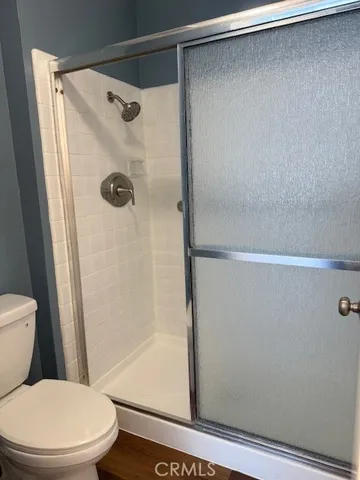 a white toilet sitting next to a bath tub and shower