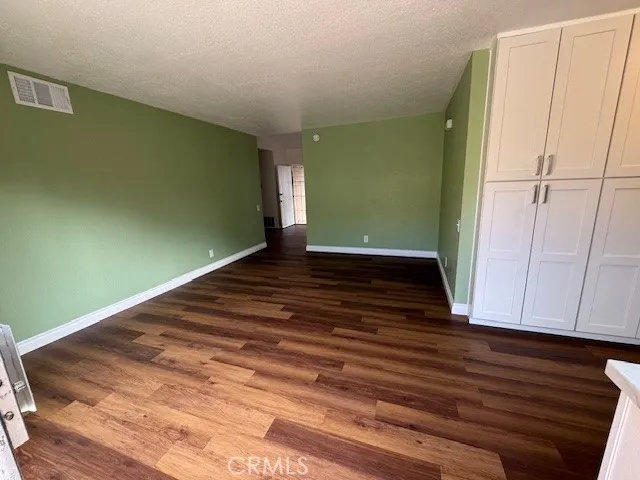 a view of a room with wooden floor