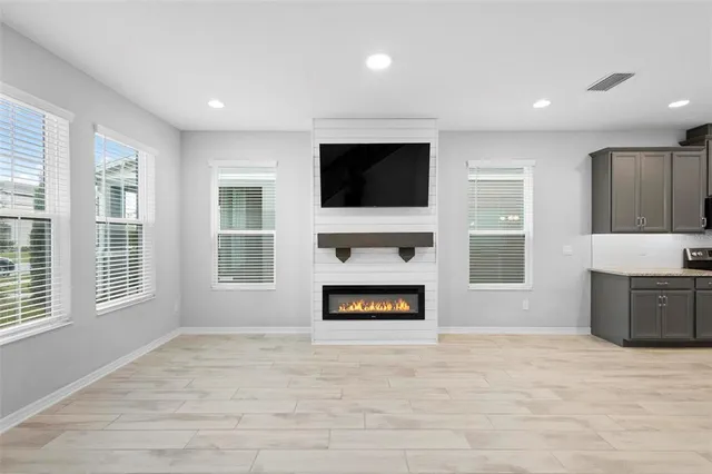 a living room with fireplace fireplace and flat screen tv