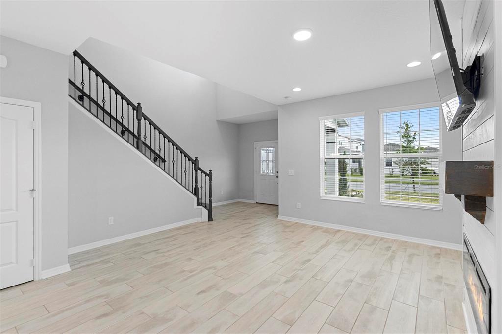 730 Rivington Drive DeBary, FL 32713 - Photo 16 of 47 a view of an empty room with a window and wooden floor