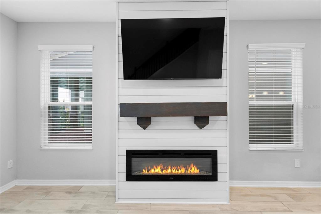 730 Rivington Drive DeBary, FL 32713 - Photo 18 of 47 a living room with a fireplace and a flat screen tv