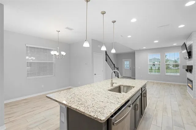 a kitchen with a sink a faucet a window and wooden floor