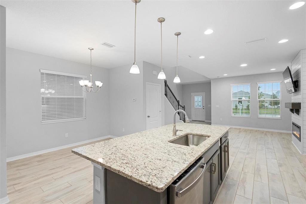 730 Rivington Drive DeBary, FL 32713 - Photo 25 of 47 a kitchen with a sink a faucet a window and wooden floor