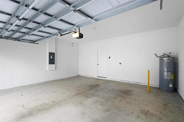 an aerial view of a house with a garden and lake view