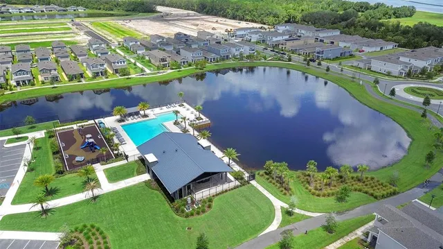an aerial view of a house with a lake view