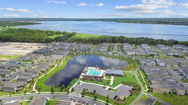 an aerial view of a house with a garden and lake view