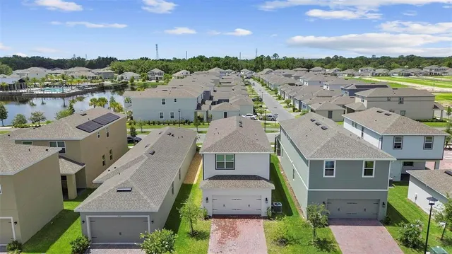 an aerial view of residential houses with outdoor space