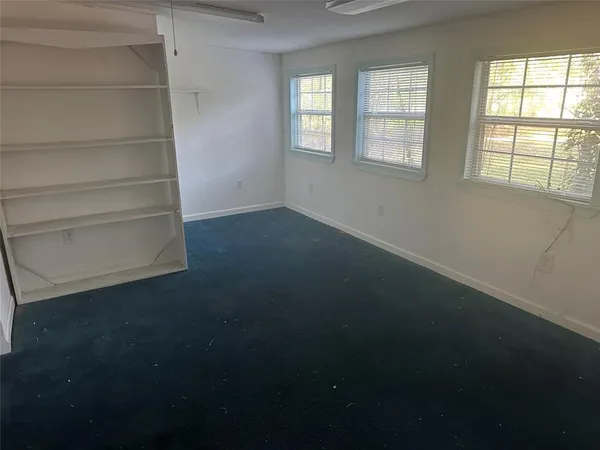an empty room with a empty space and a window