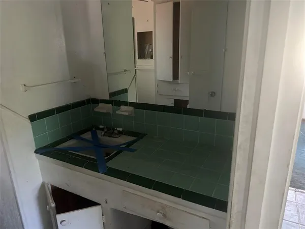 a close view of a sink and a stove in a kitchen