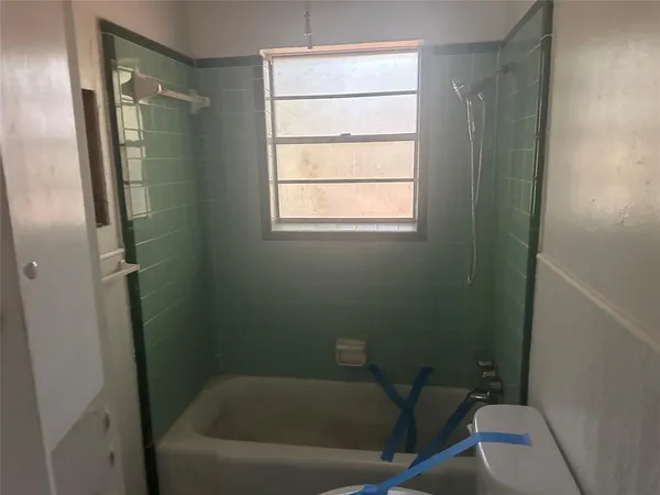 a bathroom with a bathtub and window