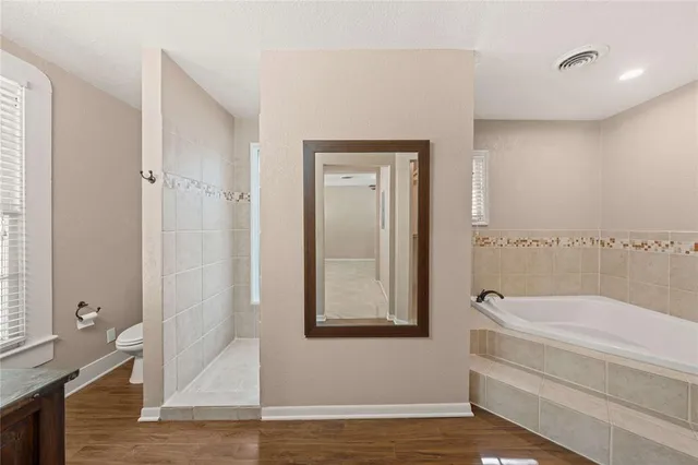a bathroom with a tub and shower