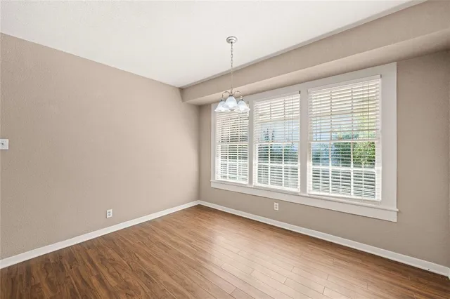 a view of a room with wooden floor and windows